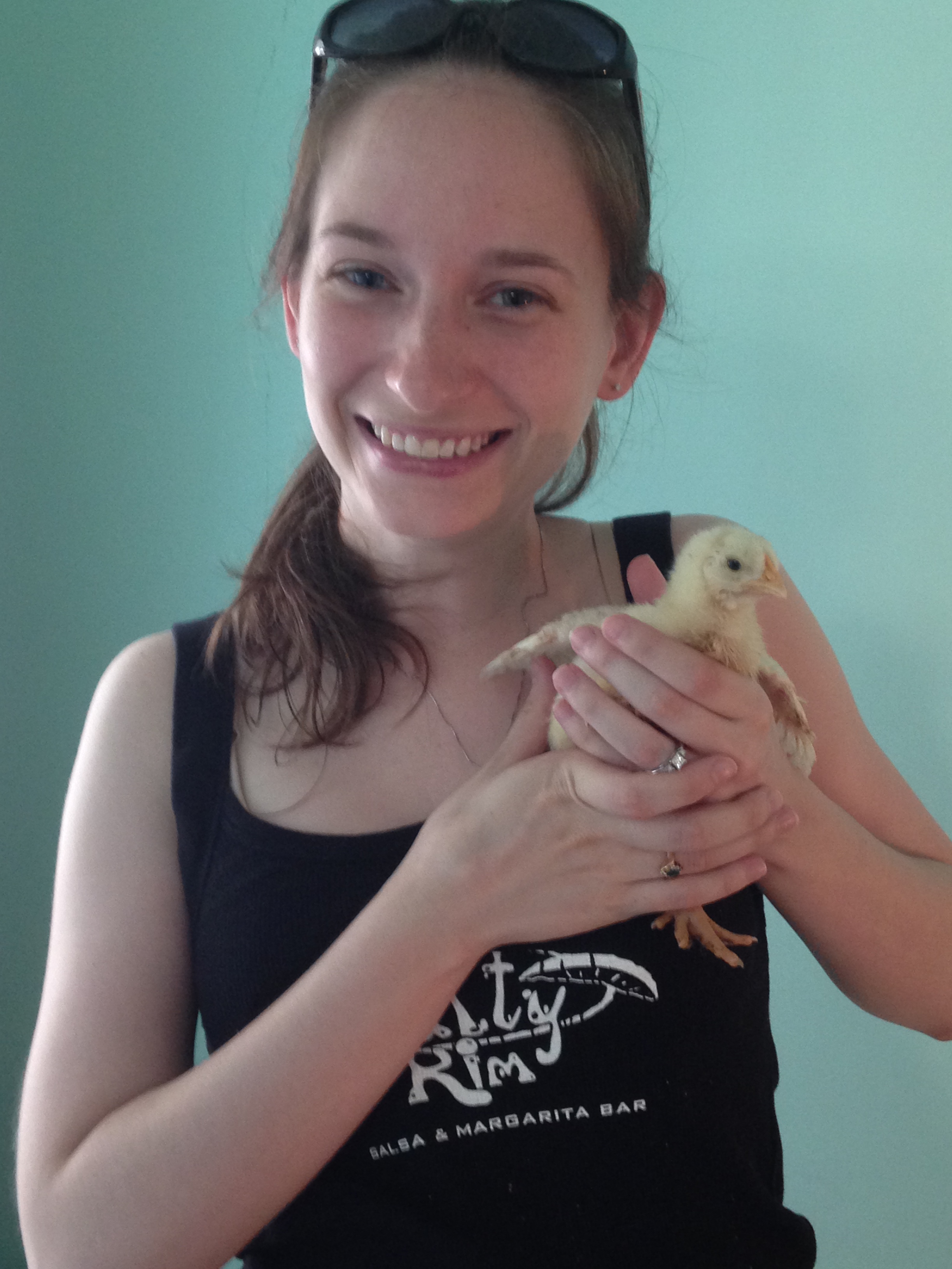 Kelly with one of her broiler chicks in the Philippines